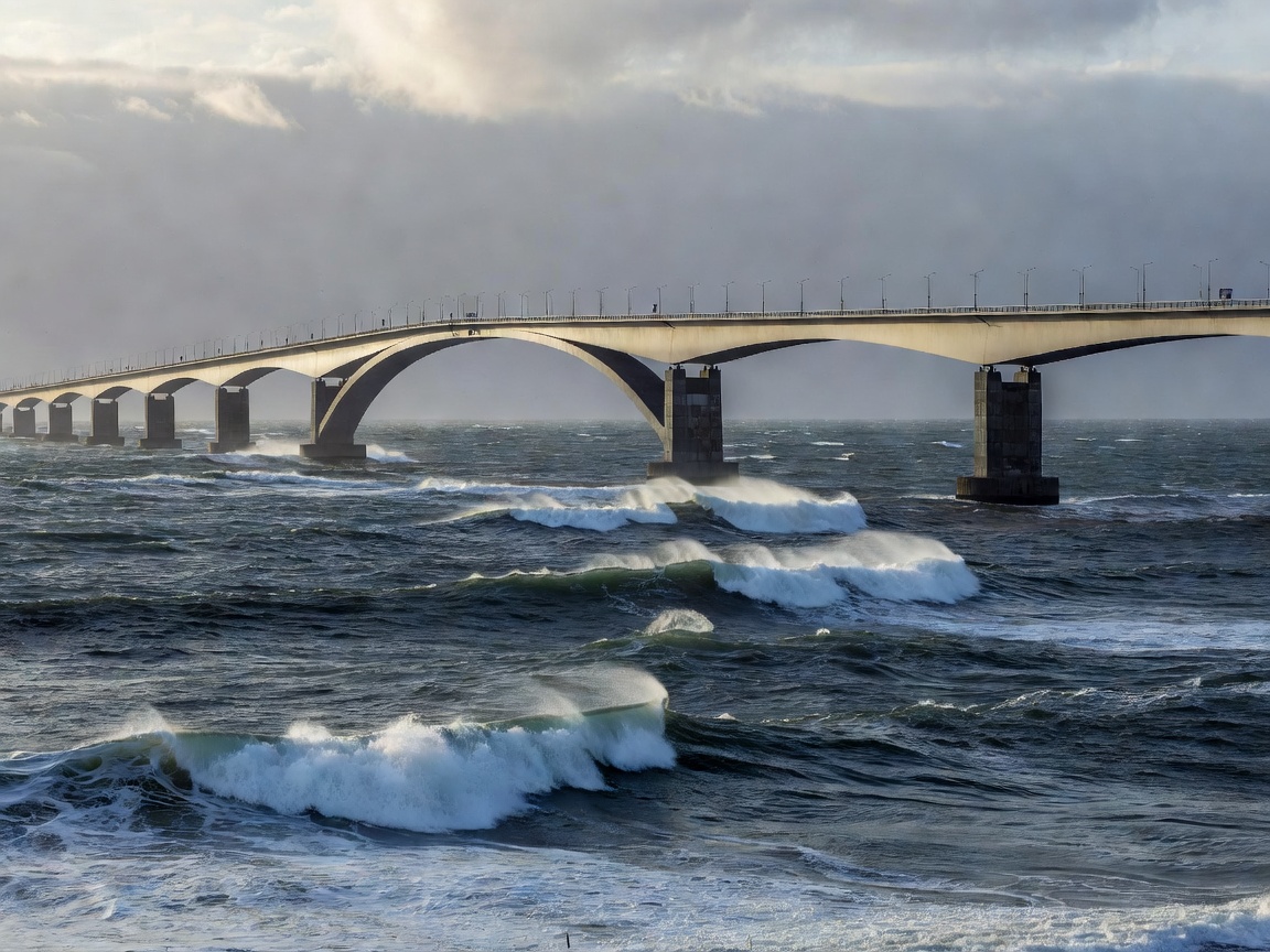 The curved cantilevers of Storseisundet Bridge sweeping across open Atlantic ocean swells